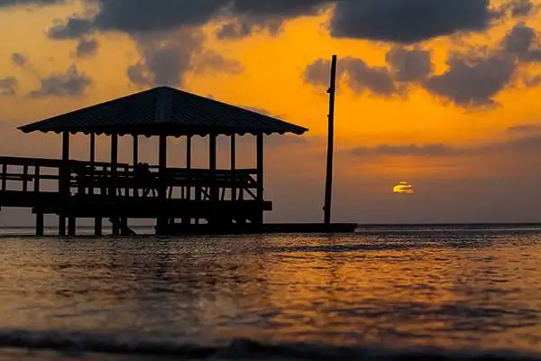 Pier on bay at sunset.